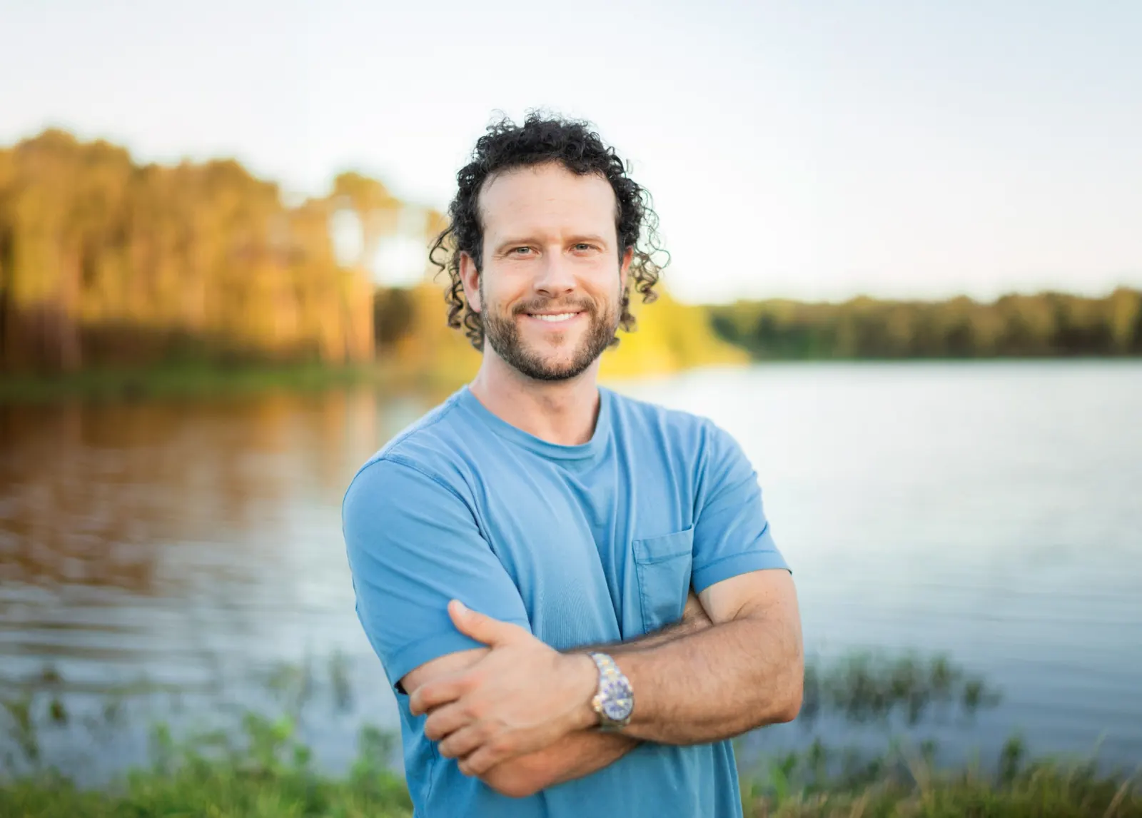 Jeff Armstrong, founder of Vesica Wellness, outdoors beside a lake